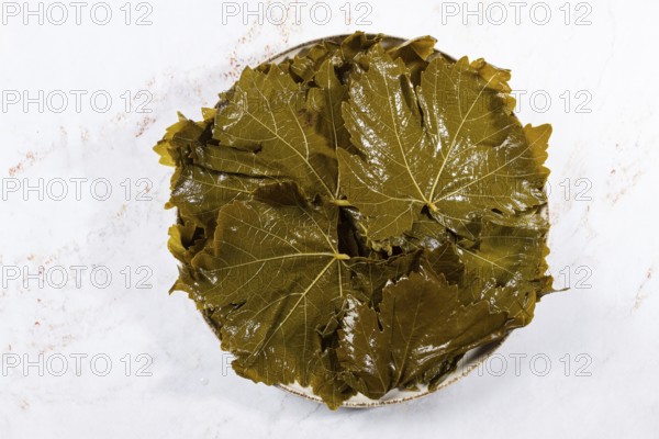 Canned grape leaves, for cooking dolma, on a plate
