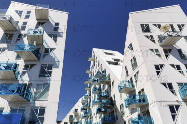 Distinctive white residential complex, turquoise balconies against blue sky, pyramid-shaped buildings, Isbjerget, iceberg, modern architecture in the harbor, Aarhus, Jutland, Denmark