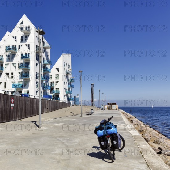 E-bike with luggage bags, bike tour, pyramid-shaped buildings, sunny summer weather, Isbjerget residential district, iceberg, modern architecture overlooking the sea, Aarhus, Jutland, Denmark