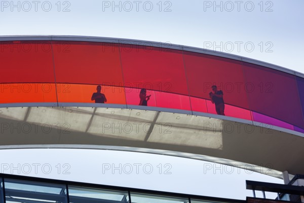 Colourful art installation Your Rainbow Panorama, artist Olafur Eliasson, ARoS, Aarhus art museum with roof installation and visitors, backlight, Aarhus, Jutland, Denmark