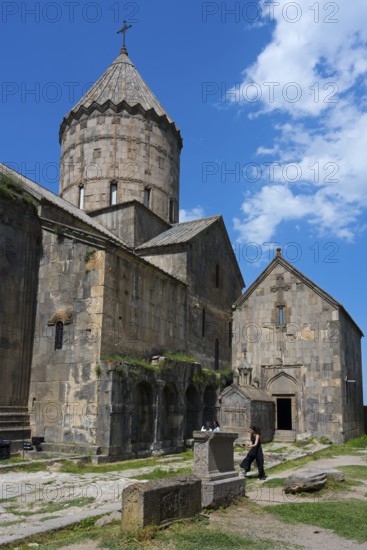 Old church with a distinctive tower and massive stone walls, divided into various building complexes under a clear sky, Surb Pogos-Petros main church, Tatev monastery, Armenian Apostolic monastery, Syunik province, Caucasus, Armenia