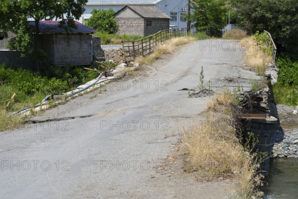 An old, damaged bridge crosses a small river in a rural area, bridge over the Debed River, Ayrum, Tavush province, Tavush, Armenia