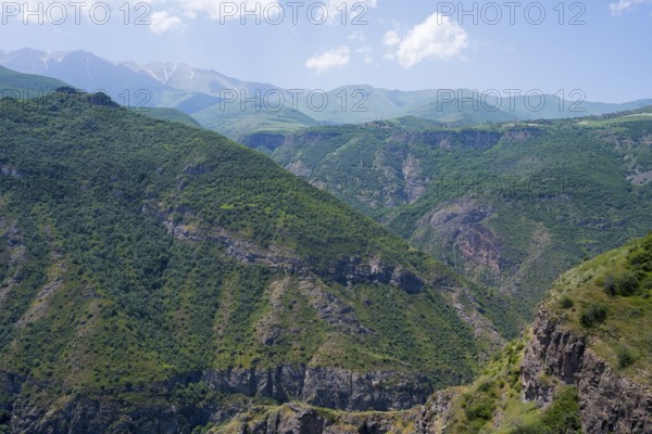 Green mountains with scattered clouds in the sky, peaceful and natural surroundings, view from Halidzor observation deck towards the monastery, Tatev, Syunik province, Syunik, Armenia