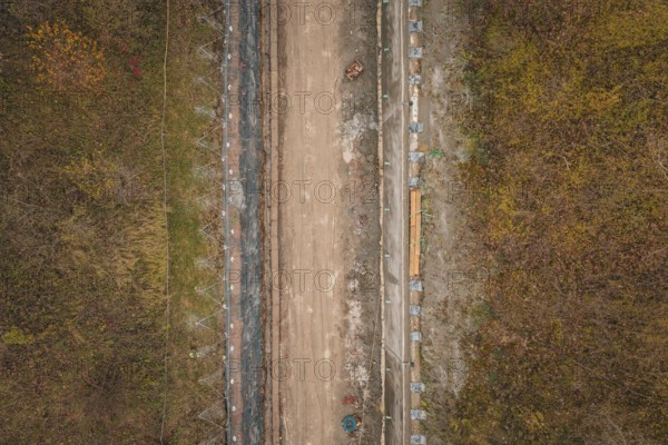 Aerial view of construction work on a road surrounded by autumnal nature, construction of the Hermann Hesse Railway, Im Hau, Calw, Germany