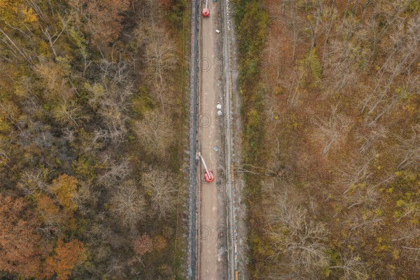 Aerial view of construction work along a slope in an autumn forest area, construction of the Hermann Hesse Railway, Im Hau, Calw, Germany