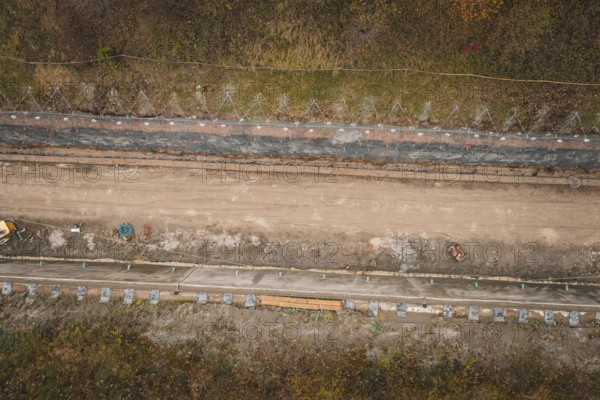 Aerial view of a construction site in an autumn area with construction along a path, construction of the Hermann Hesse Railway, Im Hau, Calw, Germany
