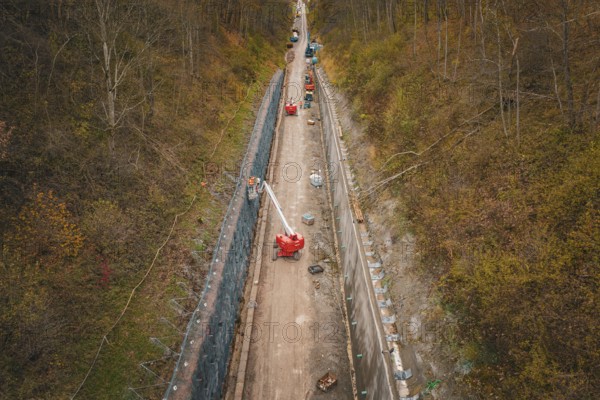 Aerial view of construction on a path between autumn trees, construction of the Hermann Hesse Railway, Im Hau, Calw, Germany