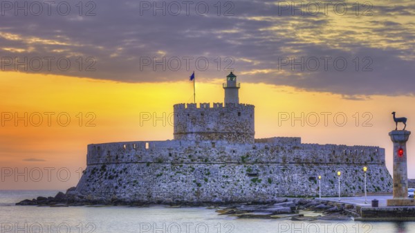 Agios Nikolaos fortress, picturesque castle with lighthouse at sunrise, surrounded by calm sea, UNESCO World Heritage Site, Old Town of Rhodes Town, Rhodes, Dodecanese, Greece