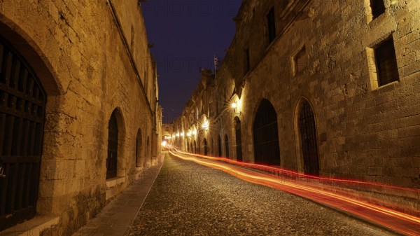 Knight City, night view of a paved street with light trails under arches, UNESCO World Heritage Site, Old Town of Rhodes Town, Rhodes, Dodecanese, Greece
