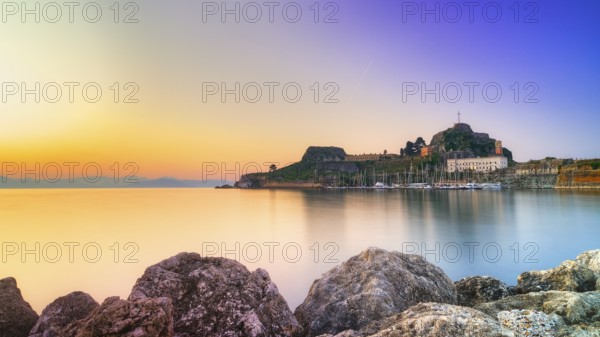 Old fortress, romantic view of a fortress at sunrise over calm water, UNESCO World Heritage Site, Old Town of Corfu, Corfu, Corfu, Ionian Islands, Greece