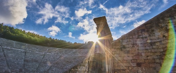 Rays of sun over ancient ruins, with a dramatic sky full of clouds, UNESCO World Heritage Site, Epidaurus, Epidaurus, Ancient Amphitheatre, Peloponnese, Greece