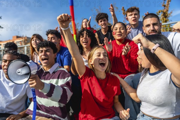 Group of diverse young activists raising fists and shouting at a daytime protest, united on campus street for justice, equality and positive social change