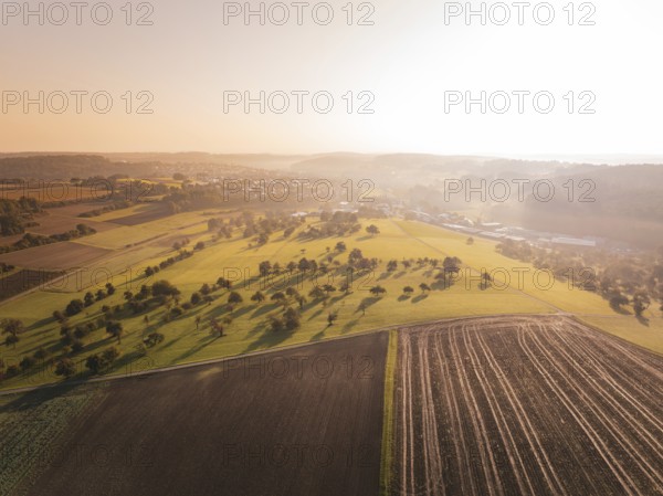 Natural landscape from the air with fields and trees at sunset, Gechingen, Germany