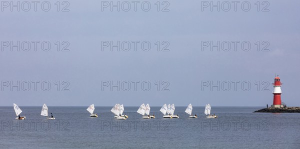 Sailing course with Optimist class sailboats, a sailing dinghy and the pier fire in Warnemünde, Baltic Sea, Mecklenburg-Western Pomerania, Germany
