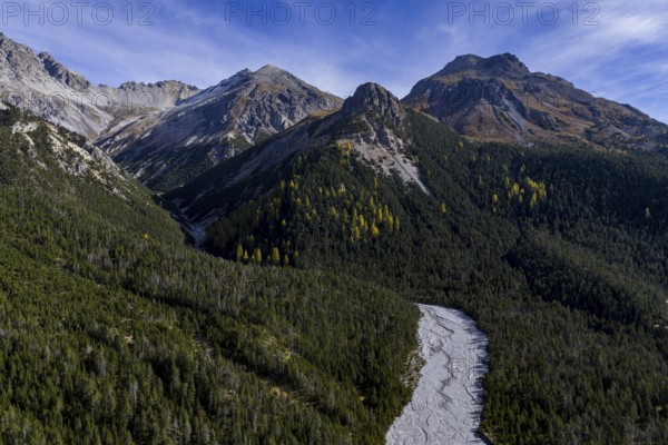 Mountain landscape, wild, untouched, coniferous forest, sunny, riverbed, autumn, aerial view, Val Müstair, Swiss National Park, Switzerland