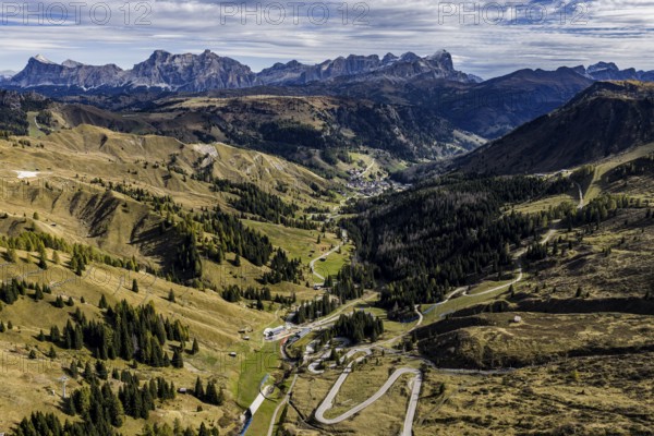 Road, curves, serpentines, pass road, autumn, sunny, Pordoi Pass, view of Tofana Group, Dolomites, Italy