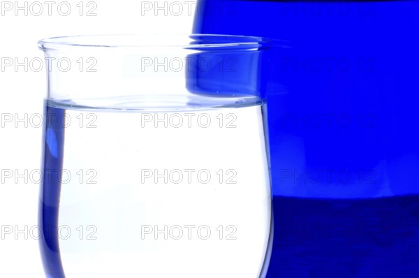 Glass with mineral water, small carbonated pearls on the edge of the glass, drinking water
