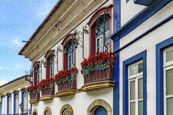 Facade of an old colonial-style houses with flowered balconies in the city of Ouro Preto, Minas Gerais, Ouro Preto, Minas Gerais, Brazil