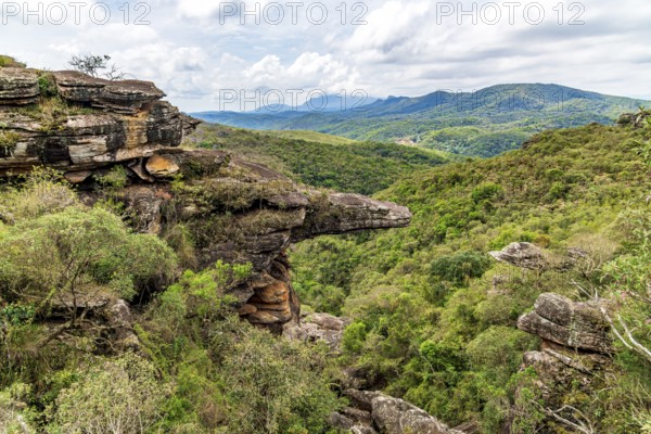 Mountains and forests of the state of Minas Gerais and a rock formation known as the Alligator Rock