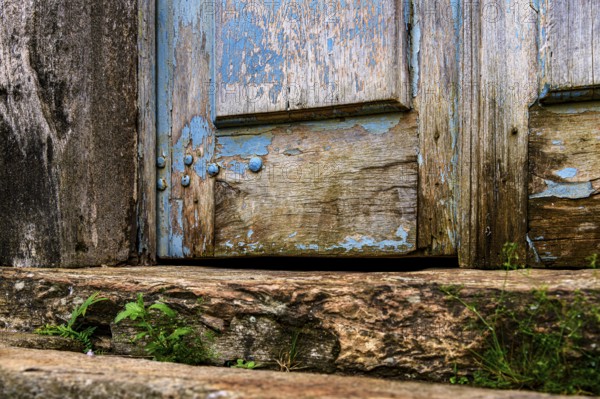 Details of an old baroque church door made of wood, weathered by time, in Ouro Preto city, Ouro Preto, Minas Gerais, Brazil