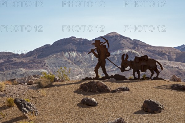 Beatty, Nevada - Art is the attraction in Rhyolite, a town that boomed briefly after gold was discovered in 1904. A gold prospector and his burro remind tourists of the town's history