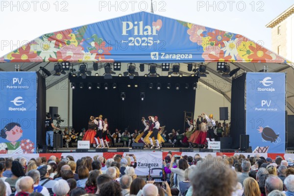Folk dancers performing on stage as part of Pilar 2025 festival event, Zaragoza, Aragon, Spain