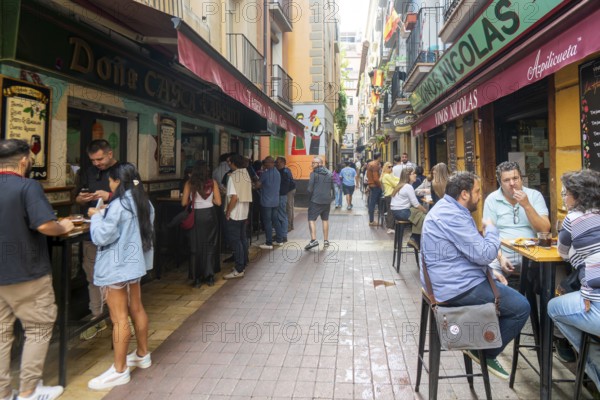 People outside tapas bars in El Tubo area of the Old Town, Zaragoza, Aragon, Spain