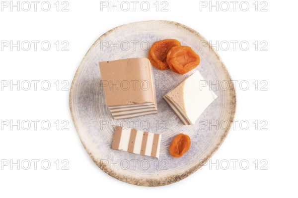 Cocoa and milk jelly with dried apricots isolated on white background, top view, flat lay, minimalism