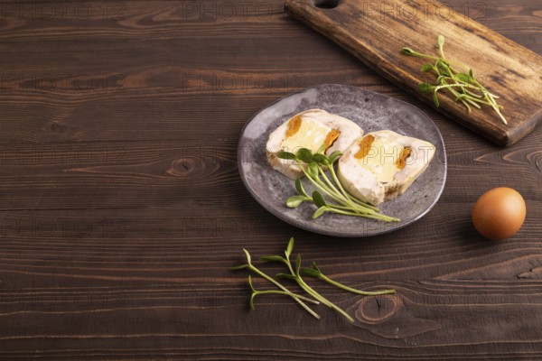 Chicken, egg and dried apricot meatloaf, microgreen on brown wooden. Diet, healthy eating. side view, copy space