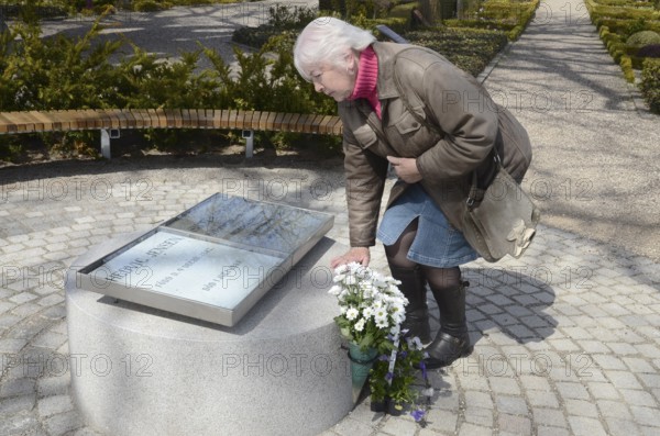 A woman looks at The grave of the love couple Danish circus artist Elvira Madigan Hedvig Jensen and Swedish officer Lieutenant Sixten Sparre at Landets Cemetery, Tåsinge Island, Funen, Denmark, Scandinavia