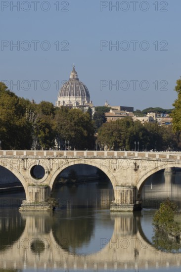 Bridge over the river Tiber with the dome of St. Peter's Basilica in the Vatican city in the background, Rome, Italy