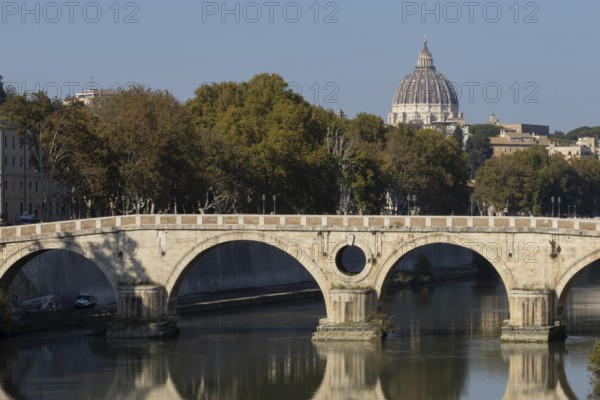 Bridge over the river Tiber with the dome of St. Peter's Basilica in the Vatican city in the background, Rome, Italy