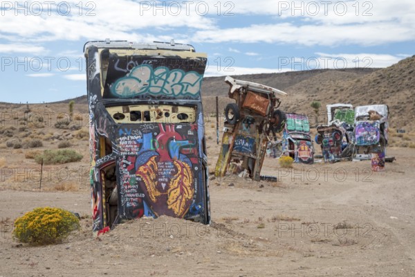 Goldfield, Nevada - The International Car Forest of the Last Church. Artist Mark Rippie has partially buried or decorated several dozen junk cars