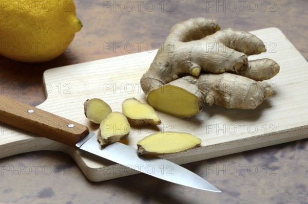 Ginger, ginger root cut with ginger slices on wooden boards