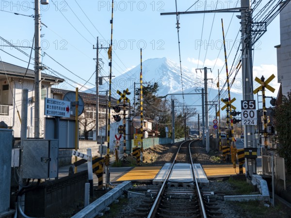 Rails of a railway line, behind Vulkan Mt. Fuji, Fujiyoshida, Yamanashi Prefecture, Japan