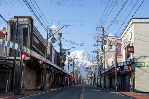 Road through the Japanese town of Fujiyoshida, behind the volcano Mt. Fuji, Yamanashi Prefecture, Japan