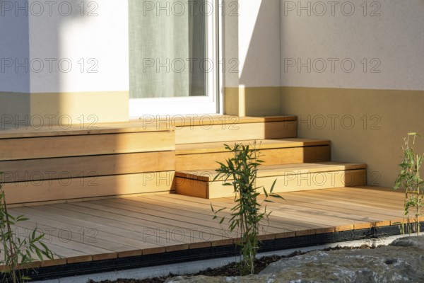 Beautiful wooden terrace on a newly landscaped garden