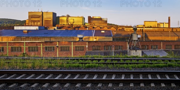 Deutsche Edelstahlwerke with train tracks at sunrise, central railway station, Witten, Ruhr region, North Rhine-Westphalia, Germany