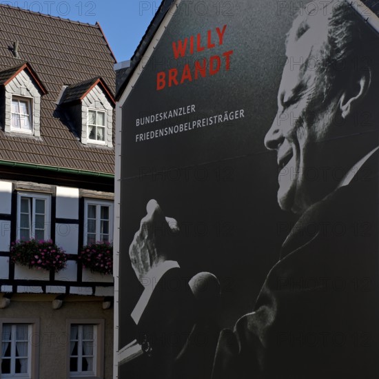Huge poster with Willy Brandt portrait on a fire wall of the Willy Brandt Forum next to a half-timbered house, Altstadt, Unkel, Rhineland-Palatinate, Rhineland, Germany