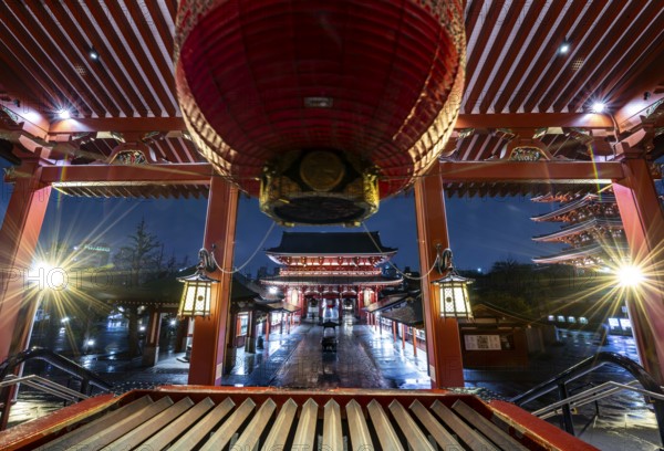 View from the main hall with a huge red lantern to the illuminated Hozomon Schazkammer Gate of Asakusa Shrine or Senso-ji Temple, at night, Buddhist temple complex, Asakusa, Tokyo, Japan
