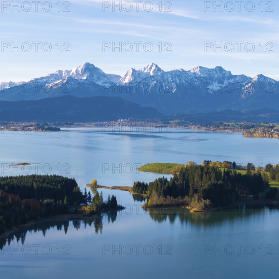 Quiet water area with forest islands and mountain range in the background, Illasbergsee, Forggensee, near Roßhaupten, Ostallgäu, Allgäu, Swabia, Bavaria, Germany