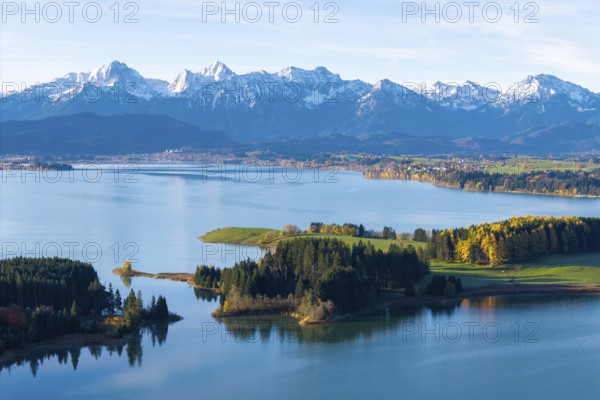 Clear lake with wooded islands against an impressive mountain backdrop, Illasbergsee, Forggensee, near Roßhaupten, Ostallgäu, Allgäu, Swabia, Bavaria, Germany