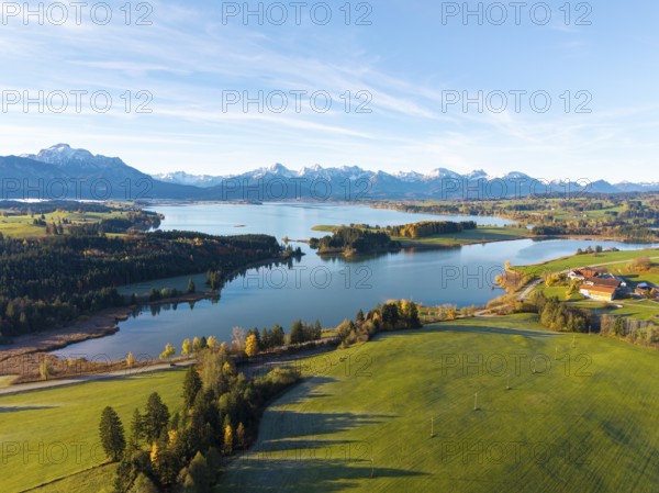 Rural scene with vast meadows and a lake, framed by mountains, Illasbergsee, Forggensee, near Roßhaupten, Ostallgäu, Allgäu, Swabia, Bavaria, Germany