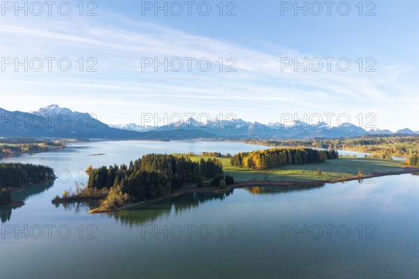 Landscape with large lake surrounded by forests and alpine landscape under blue sky, Illasbergsee, Forggensee, near Roßhaupten, Ostallgäu, Allgäu, Swabia, Bavaria, Germany