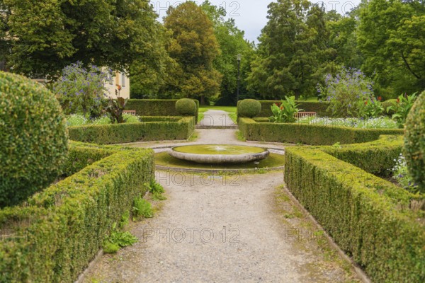 A symmetrical garden with well-kept hedges and a central path leads through the green area, ZFP Zwiefalten, Reutlingen district, Germany