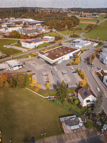 A gas station and industrial site surrounded by autumn leaves in a rural area, Althengstett, Calw district, Germany