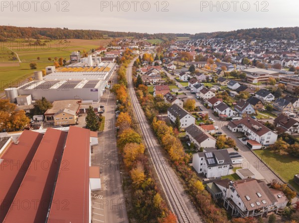 An autumnal panorama with a Hermann Hesse Railway railway line red roofs and residential buildings in a rural area, Althengstett, Calw district, Germany