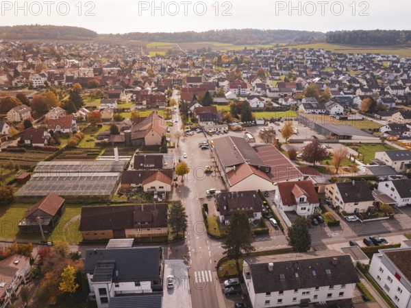 An urban landscape in autumn with narrow roads, residential buildings and autumn vegetation, Althengstett, Calw district, Germany