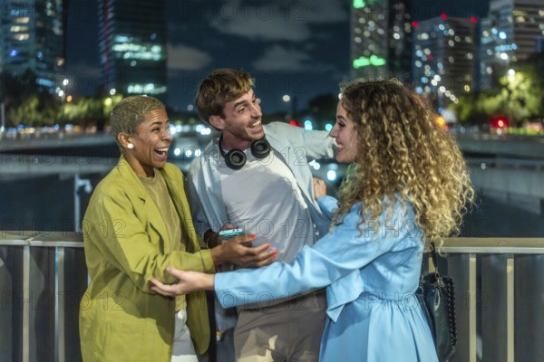 Diverse young adults laughing and bonding on a city bridge at night, candidly enjoying each other's company with blurred illuminated skyline lights in the background, joyful and spontaneous