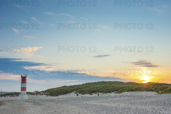Red, white lighthouse Heligoland dune (Oberfeuer), striped, south beach, beach chairs, dunes, common beach oats (Ammophila arenaria (L.) Link, syn.: Calamagrostis arenaria (L.) Roth), wide sky, peaceful, in the background the main island, deserted, no one, warm, gentle sunlight at sunset, evening mood, relaxed atmosphere, atmospheric, colorful, quiet, vacation, summer, evening sun, Dune island, Heligoland, Pinneberg district, Schleswig-Holstein, North Sea, Germany